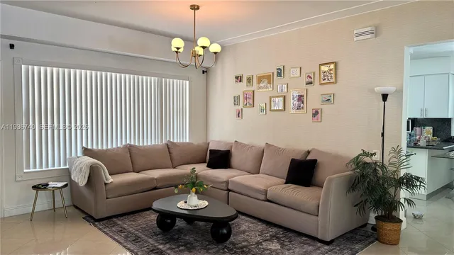 a living room with furniture and a chandelier