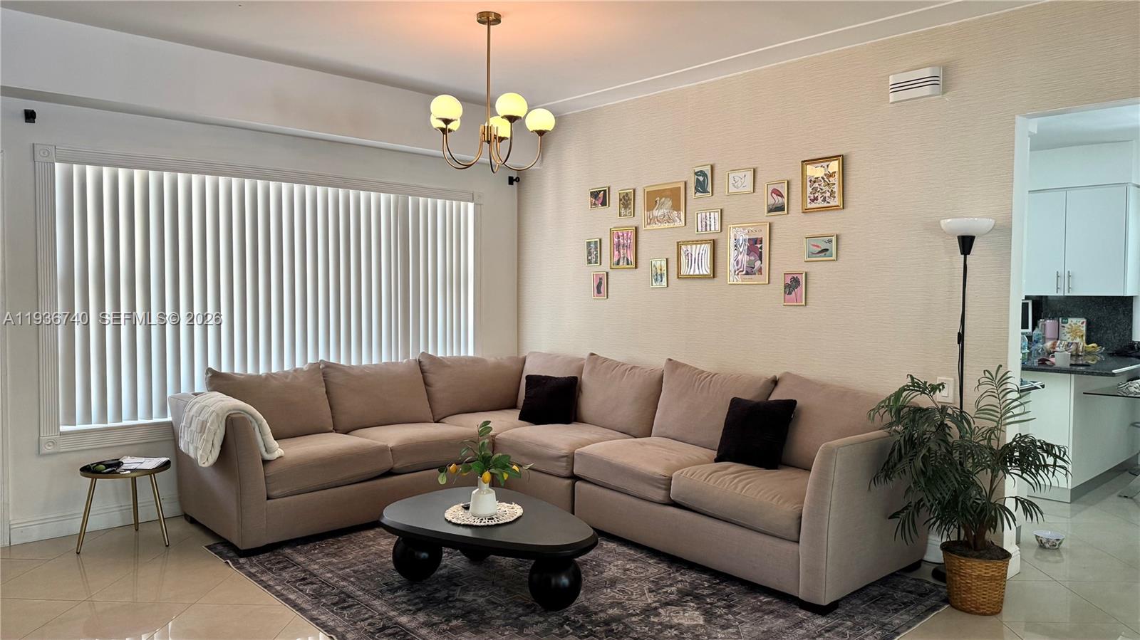 1611 71st Street Miami Beach, FL 33141 - Photo 3 of 16 a living room with furniture and a chandelier