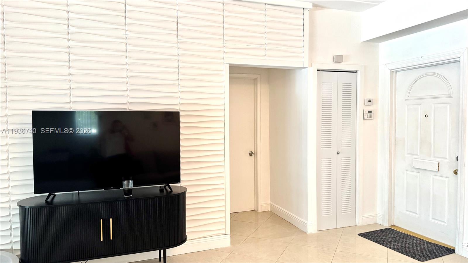 1611 71st Street Miami Beach, FL 33141 - Photo 5 of 16 a living room with furniture and a flat screen tv