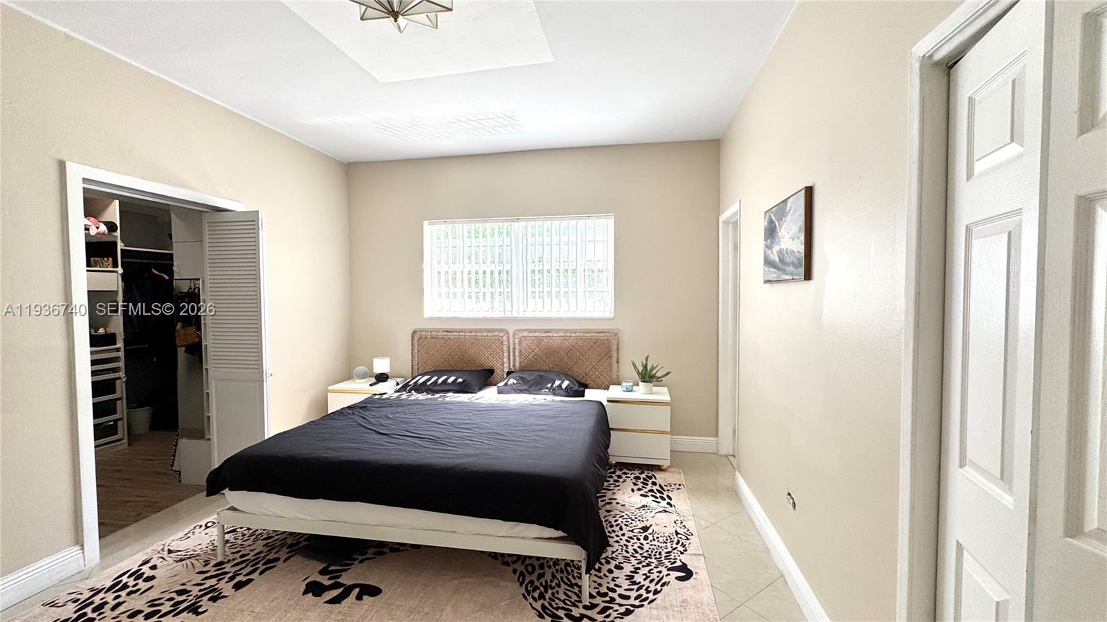 1611 71st Street Miami Beach, FL 33141 - Photo 9 of 16 a bedroom with a bed and window