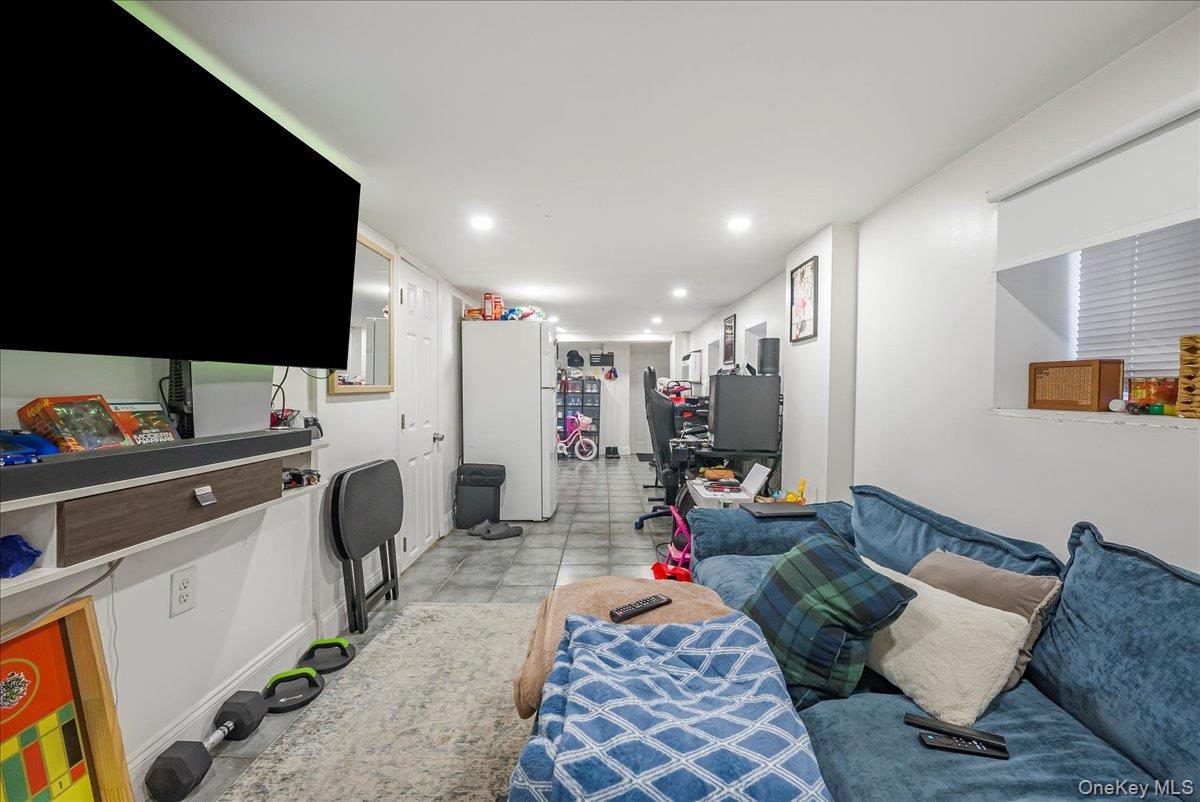1526 Kennellworth Place Bronx, NY 10465 - Photo 12 of 37 a living room with furniture and a flat screen tv