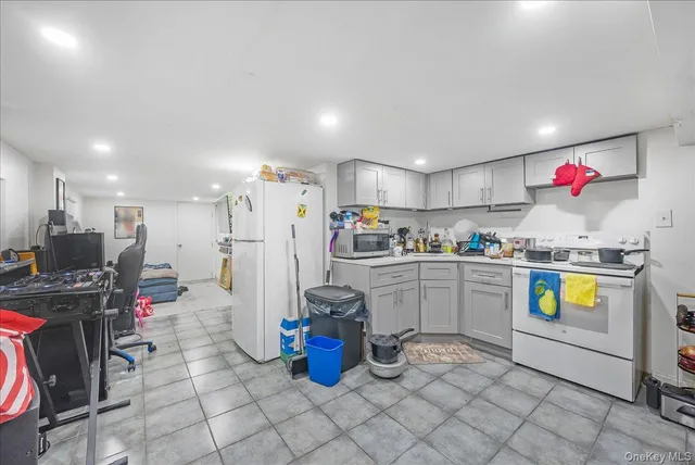 a kitchen with stainless steel appliances granite countertop a sink cabinets and window