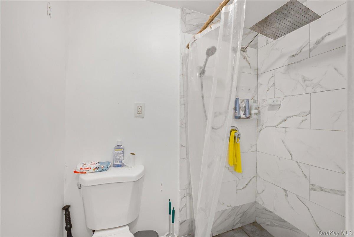 1526 Kennellworth Place Bronx, NY 10465 - Photo 17 of 37 a bathroom with a sink and a toilet