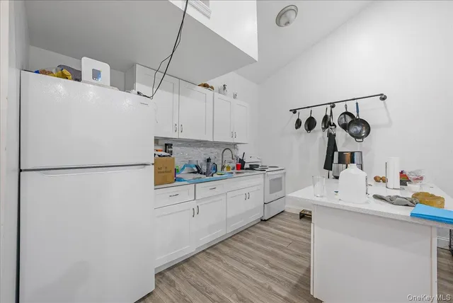 a kitchen with a refrigerator and a stove