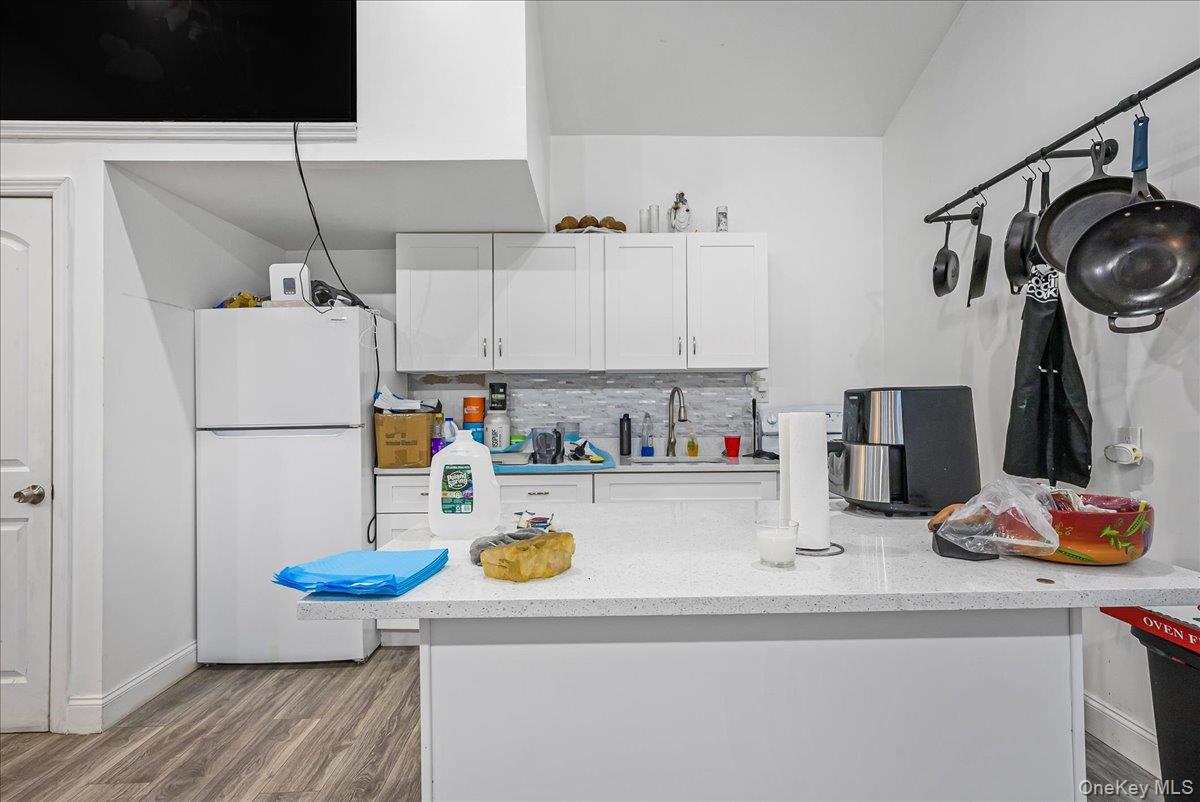 1526 Kennellworth Place Bronx, NY 10465 - Photo 19 of 37 a kitchen with a refrigerator and a stove