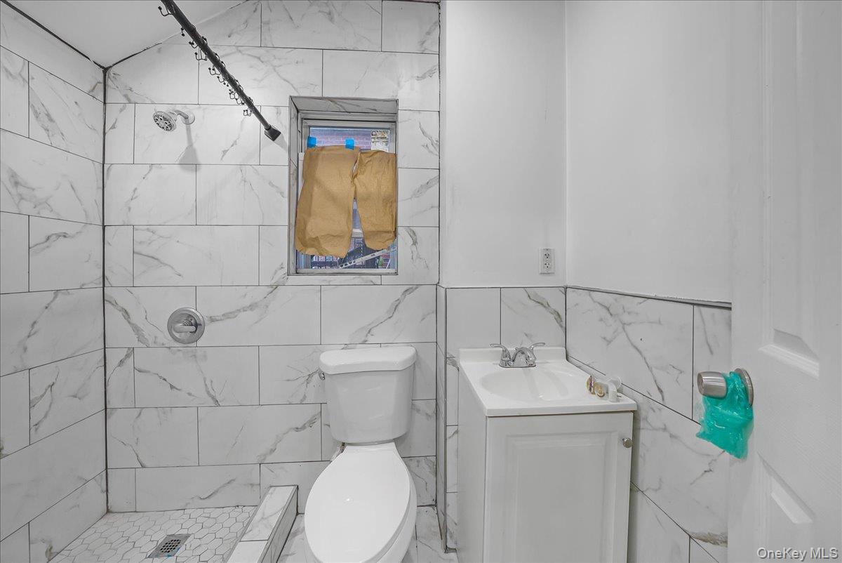 1526 Kennellworth Place Bronx, NY 10465 - Photo 24 of 37 a bathroom with a sink toilet and shower