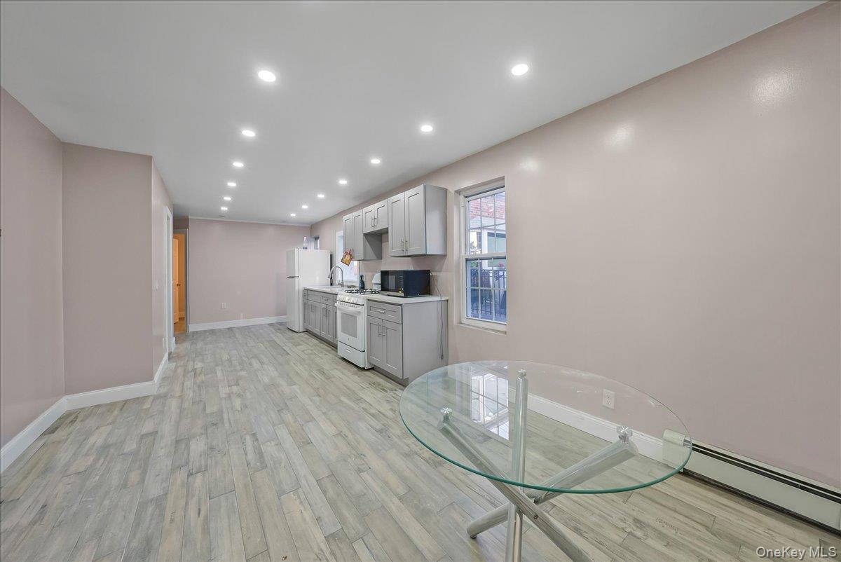 1526 Kennellworth Place Bronx, NY 10465 - Photo 26 of 37 a room with wooden floor and white cabinets