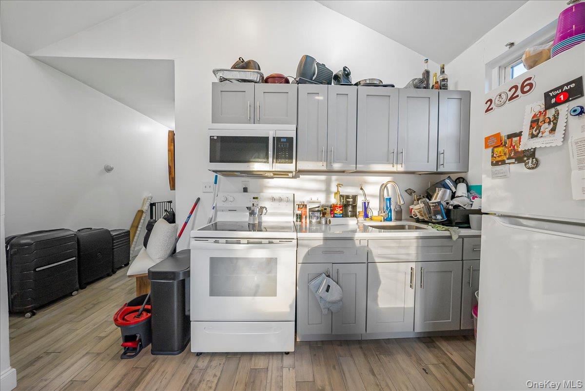 1526 Kennellworth Place Bronx, NY 10465 - Photo 34 of 37 a kitchen with cabinets and appliances