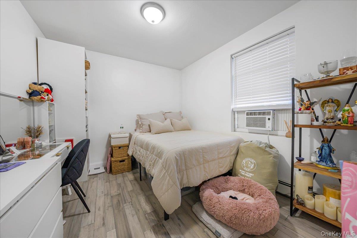 1526 Kennellworth Place Bronx, NY 10465 - Photo 36 of 37 a bedroom with a bed and wooden floor