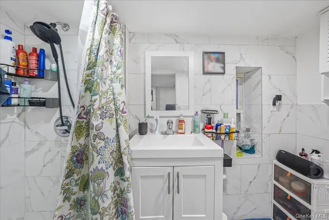 a view of walk in closet with clothes