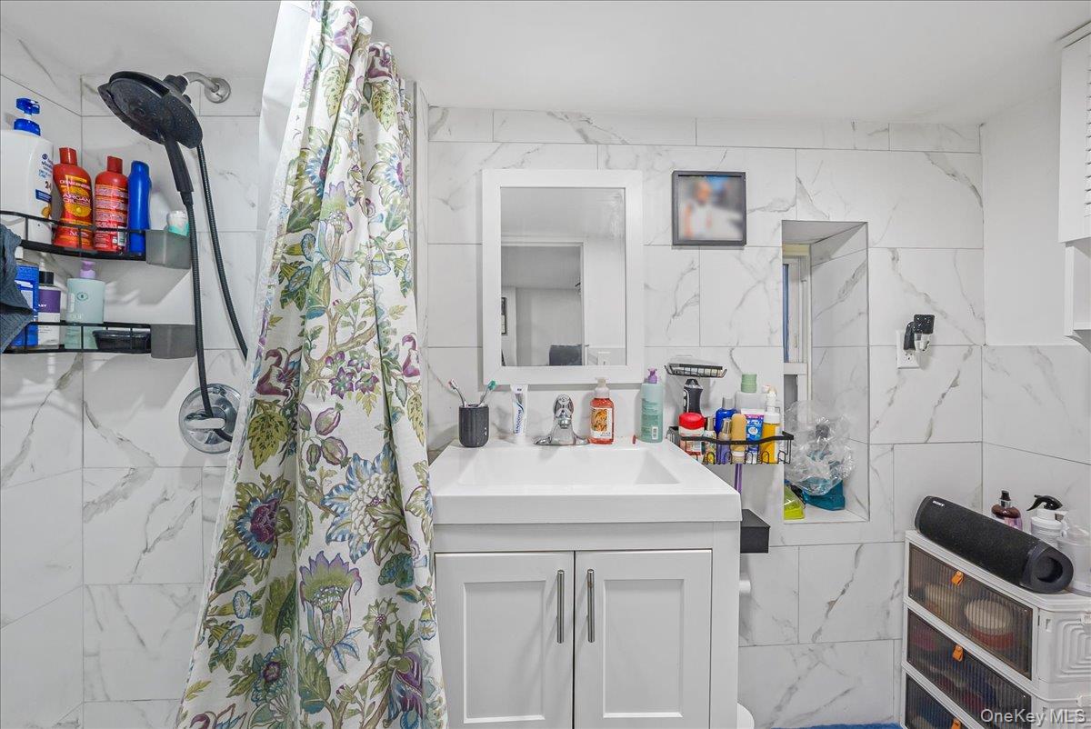 1526 Kennellworth Place Bronx, NY 10465 - Photo 10 of 37 a bathroom with a sink and a mirror
