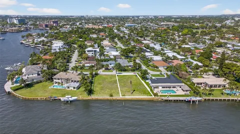 an aerial view of a residential houses with outdoor space and street view