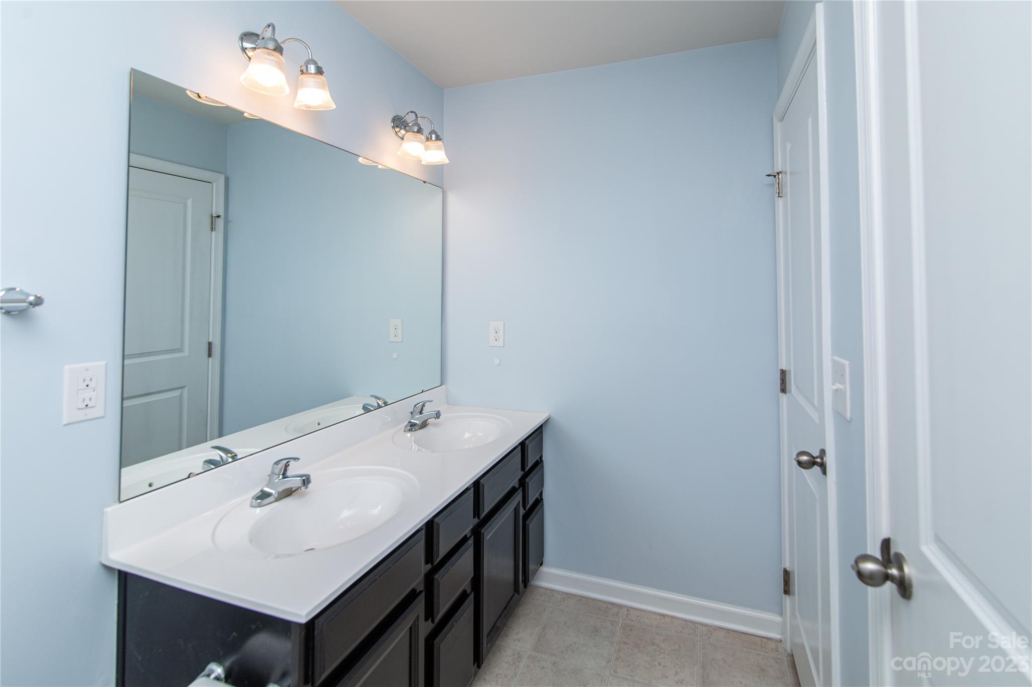 1151 Tangle Ridge Drive Southeast Concord, NC 28025 - Photo 14 of 22 a bathroom with a sink vanity and mirror