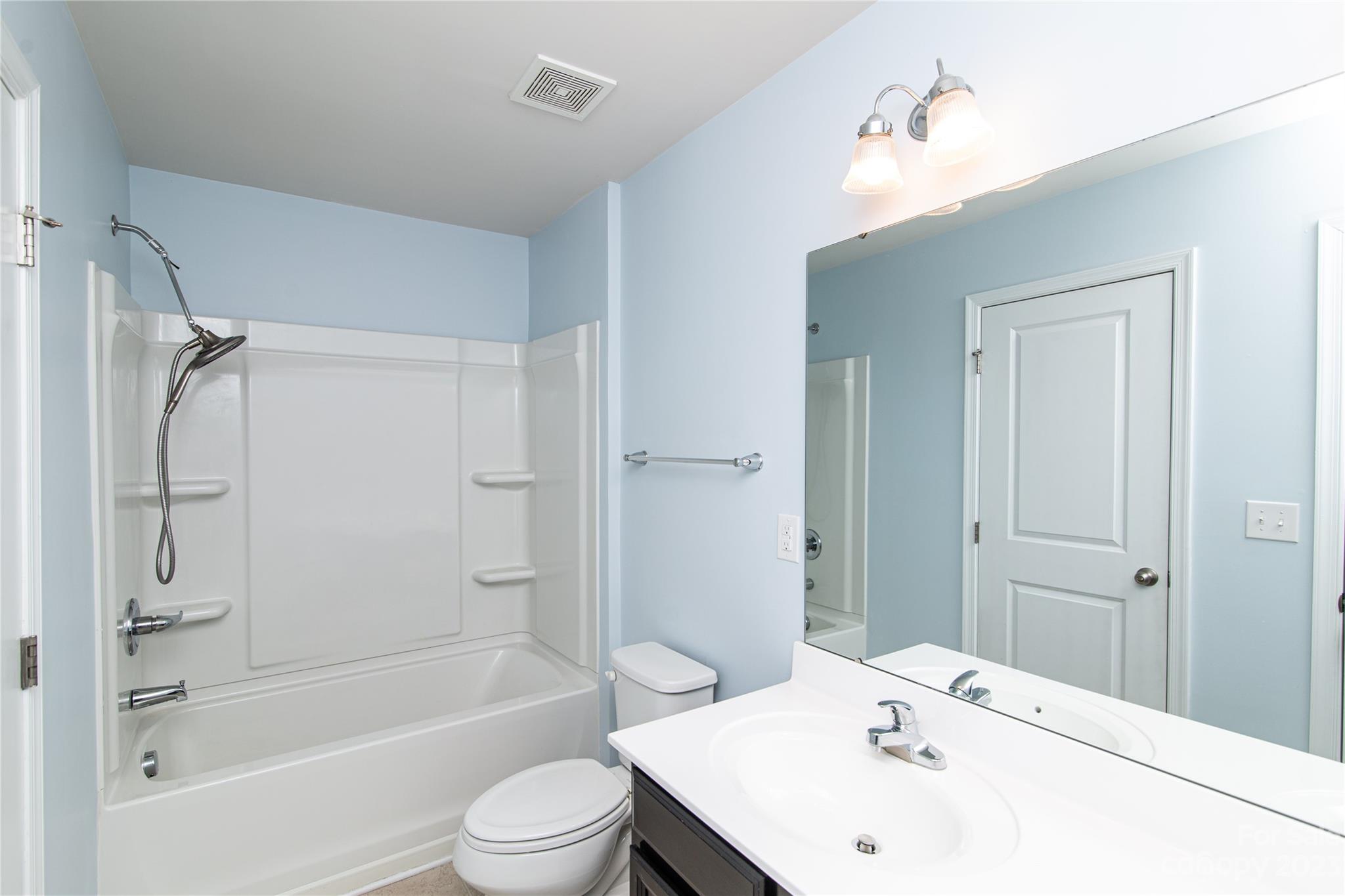 1151 Tangle Ridge Drive Southeast Concord, NC 28025 - Photo 15 of 22 a bathroom with a bathtub shower sink vanity and toilet