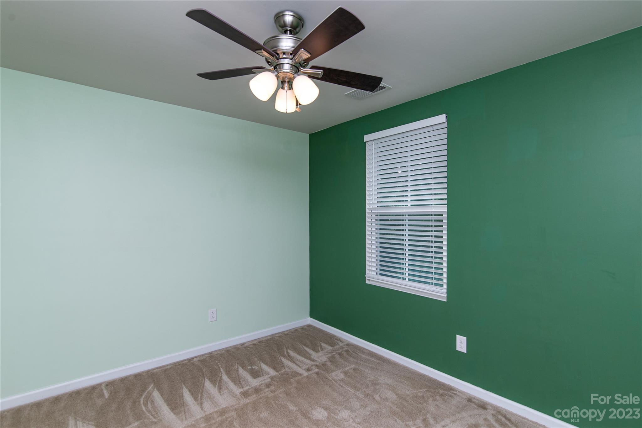 1151 Tangle Ridge Drive Southeast Concord, NC 28025 - Photo 17 of 22 an empty room with a window and a ceiling fan