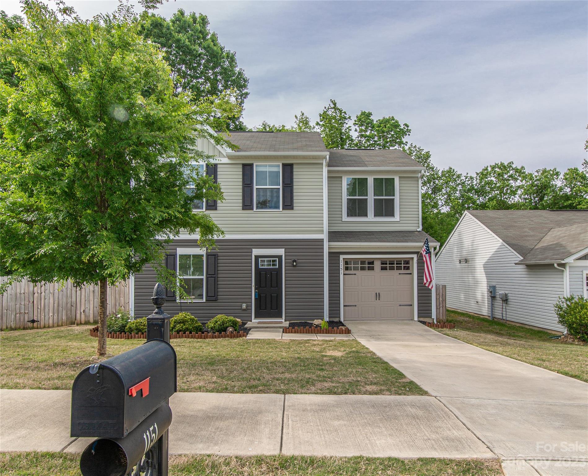 1151 Tangle Ridge Drive Southeast Concord, NC 28025 - Photo 2 of 22 a view of a house with a backyard and a tree