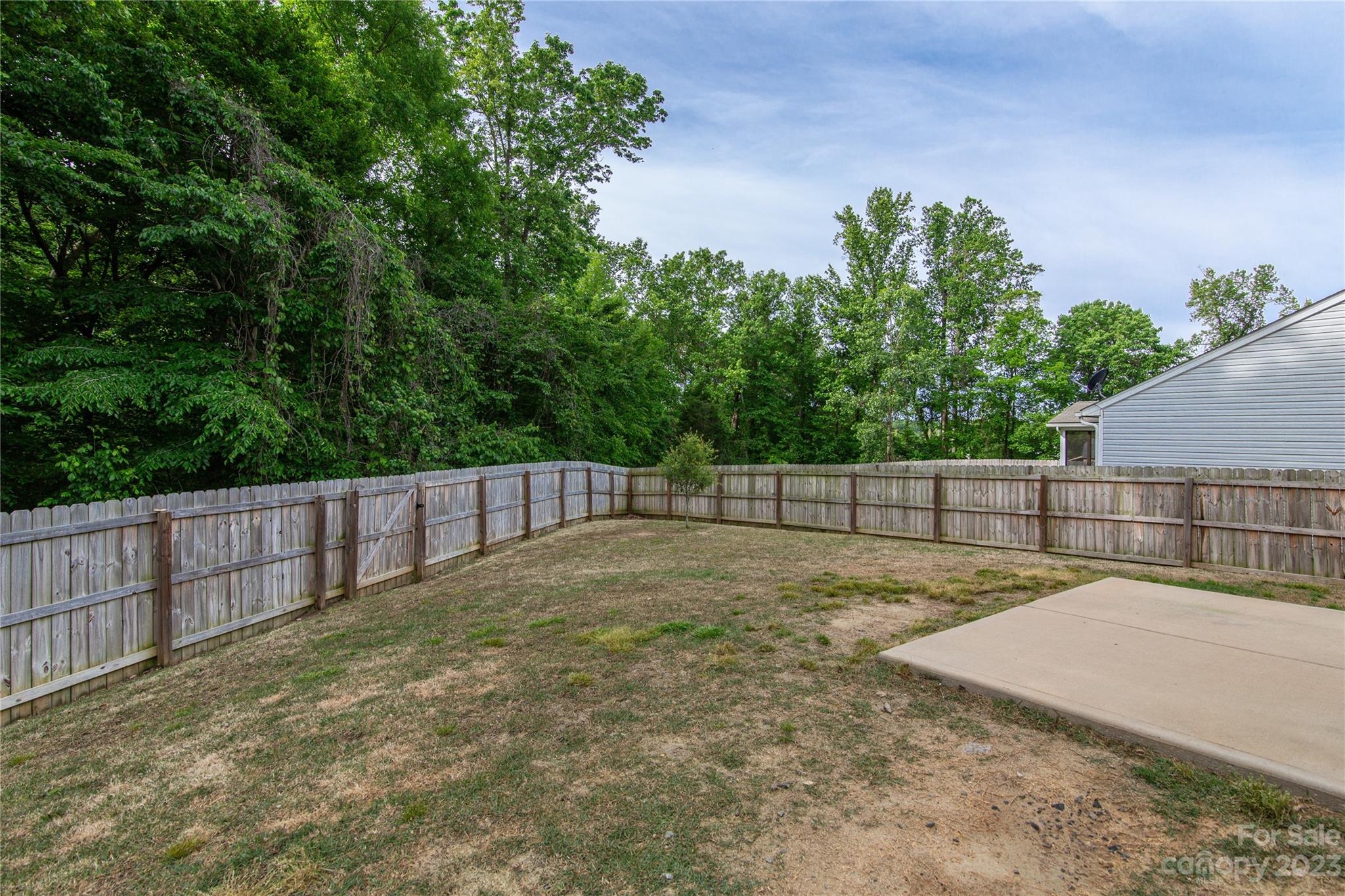 1151 Tangle Ridge Drive Southeast Concord, NC 28025 - Photo 21 of 22 a view of backyard with wooden fence