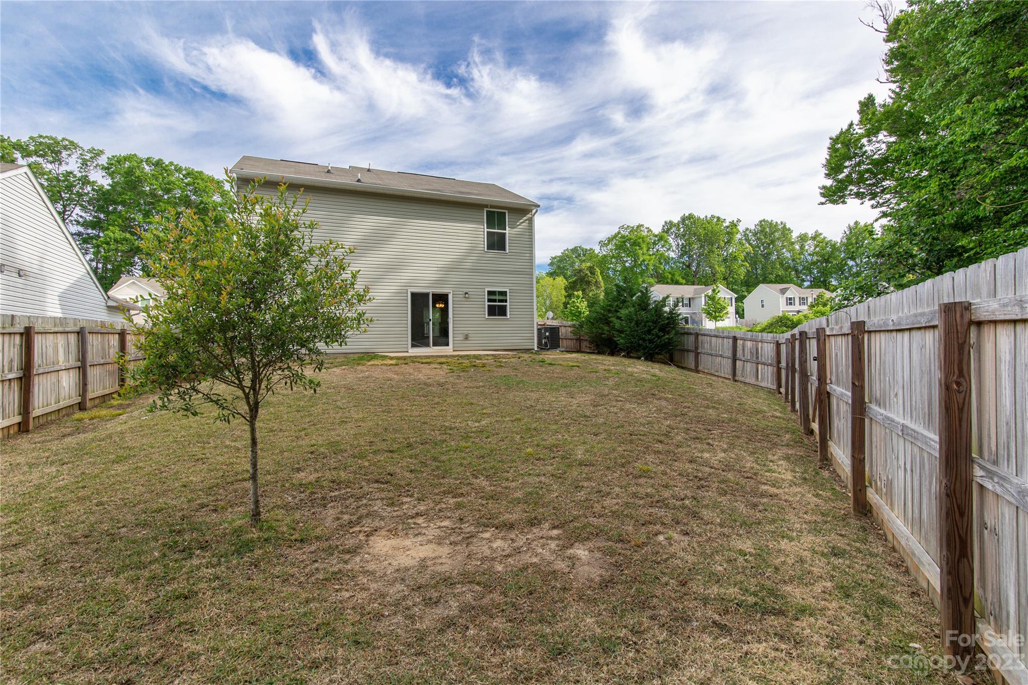1151 Tangle Ridge Drive Southeast Concord, NC 28025 - Photo 22 of 22 a view of a house with a small yard and a large tree