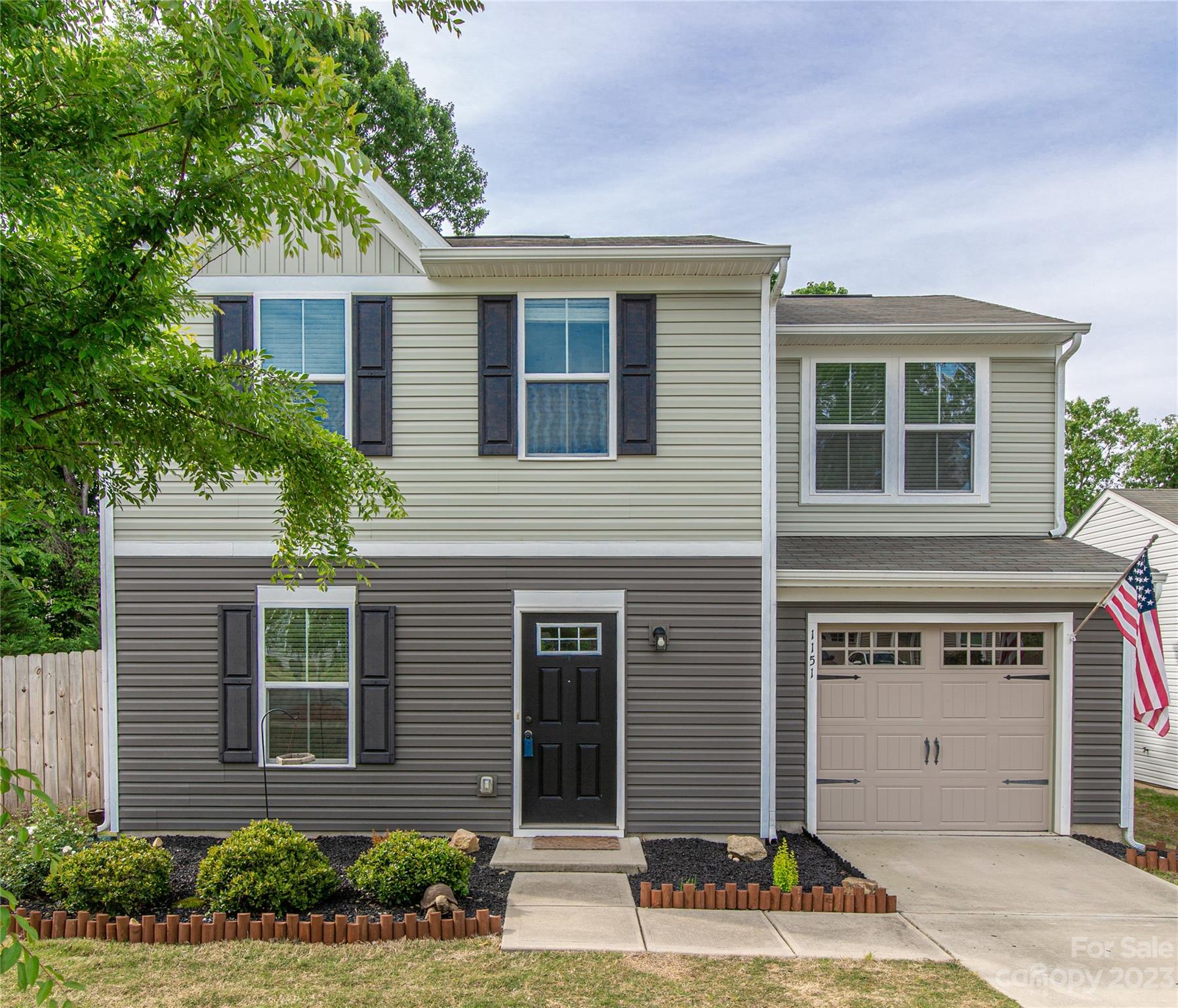 1151 Tangle Ridge Drive Southeast Concord, NC 28025 - Photo 3 of 22 a front view of a house with a yard and potted plants
