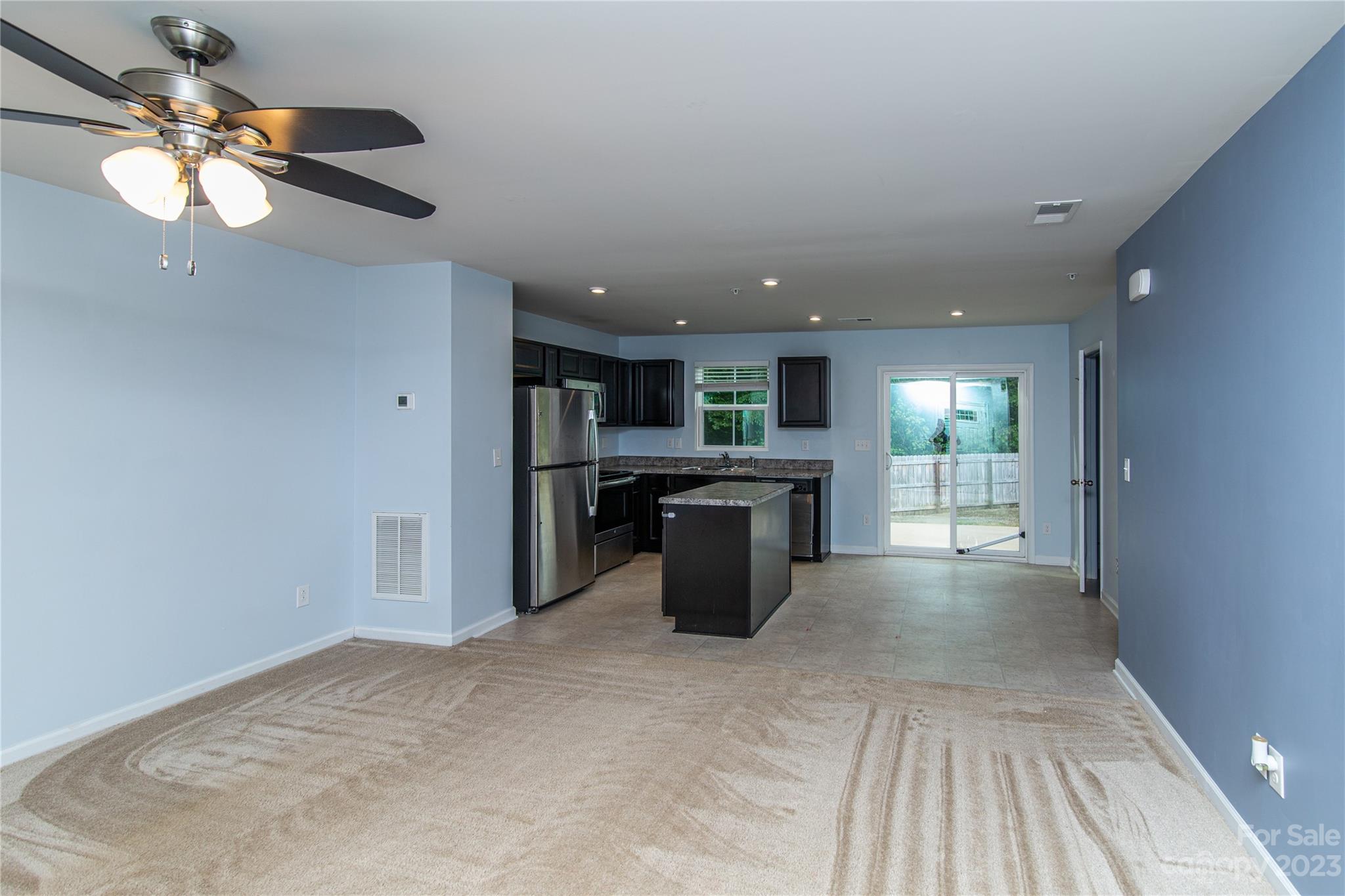 1151 Tangle Ridge Drive Southeast Concord, NC 28025 - Photo 4 of 22 a open kitchen with kitchen island white cabinets and refrigerator