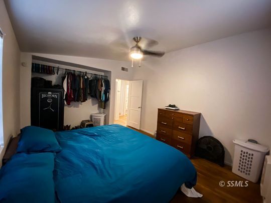 333 North Helena Street Ridgecrest, CA 93555 - Photo 16 of 35 a bedroom with a bed and a walk in closet