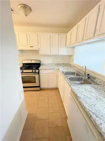 a kitchen with a stove a sink and a microwave