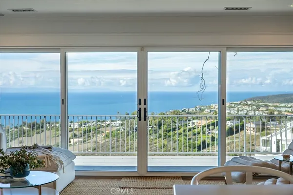 a view of a balcony with mountain view and wooden floor