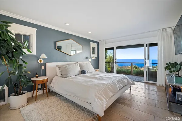 a bed room with a bed and a chair