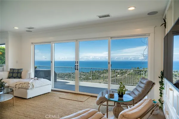 a living room with couch and a floor to ceiling window