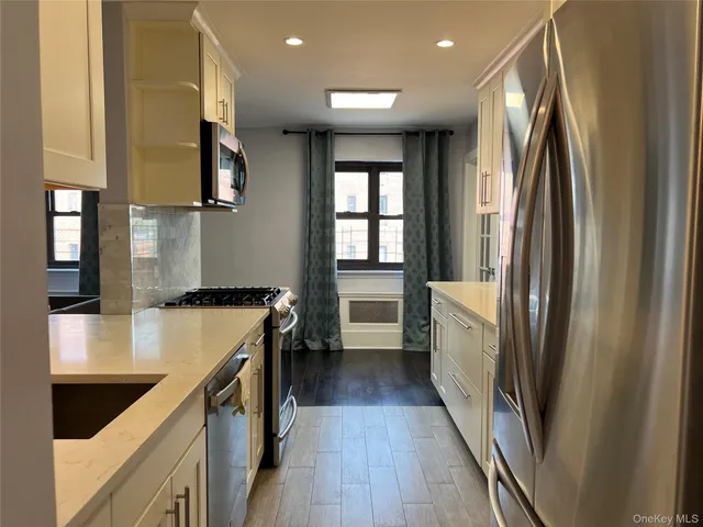 a kitchen with stainless steel appliances granite countertop refrigerator a sink and a stove