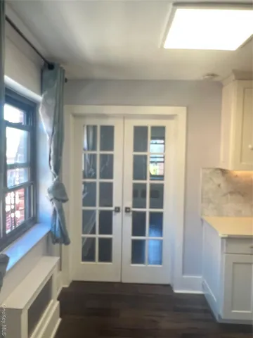 a view of wooden floor and windows in a room