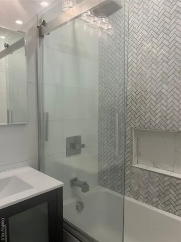 a bathroom with a shower and a sink