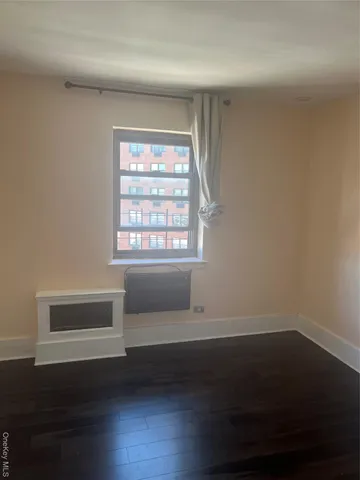 a room with a window and wooden floor