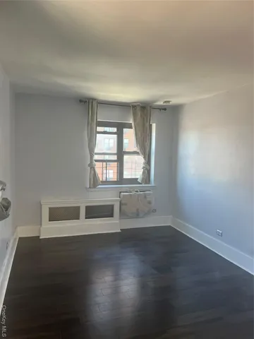 a view of wooden floor and windows in a room