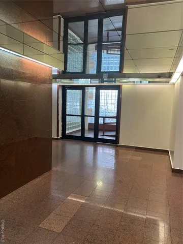 a view of a livingroom with an empty space and a window