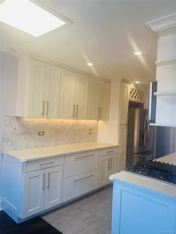 a kitchen with a sink and a refrigerator