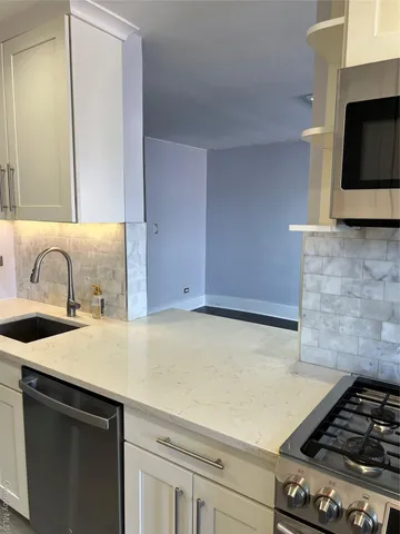 a kitchen with a sink and a stove top oven