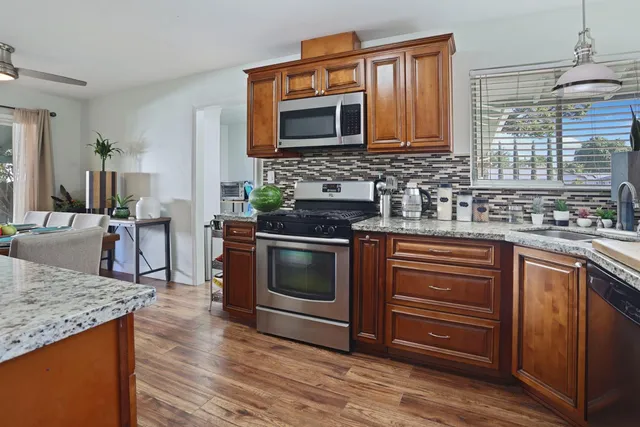 a kitchen with granite countertop a stove and a sink