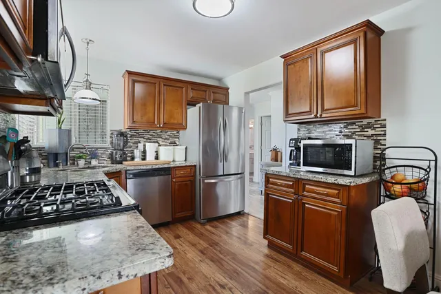 a kitchen with a stove a sink and a refrigerator