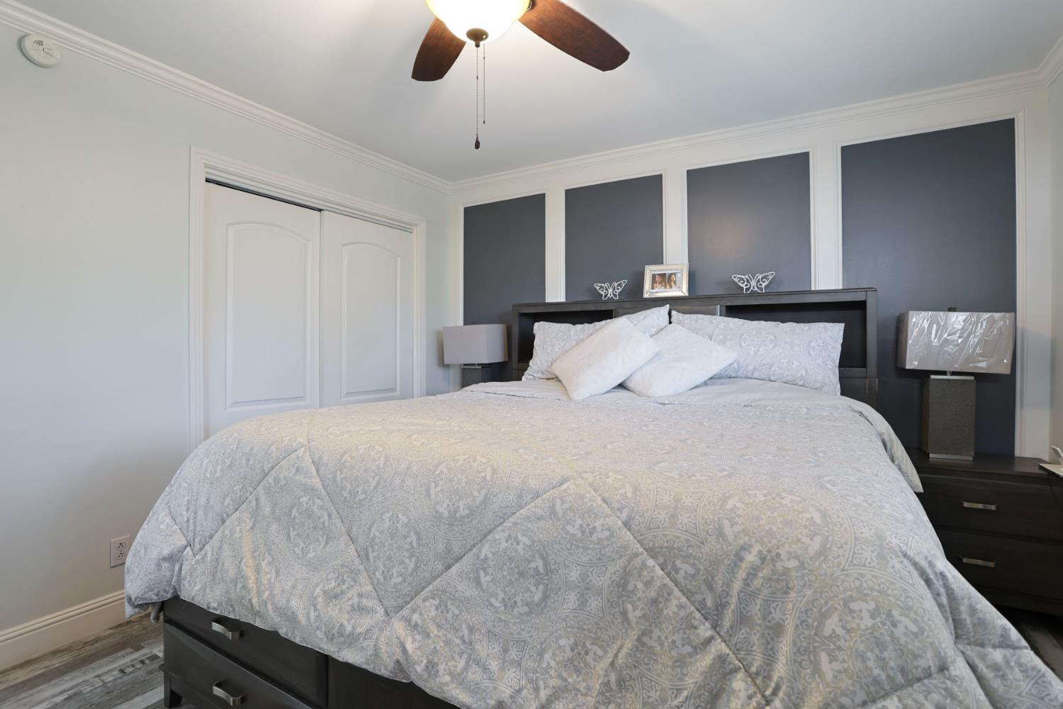 518 West Lincoln Road Stockton, CA 95207 - Photo 20 of 38 a bedroom with a bed and a chandelier