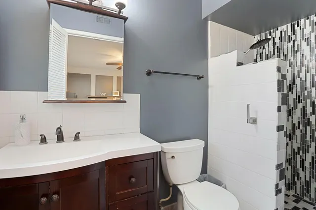 a white toilet sitting next to a bathroom sink