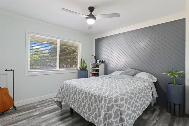 a bedroom with a large bed and a chandelier