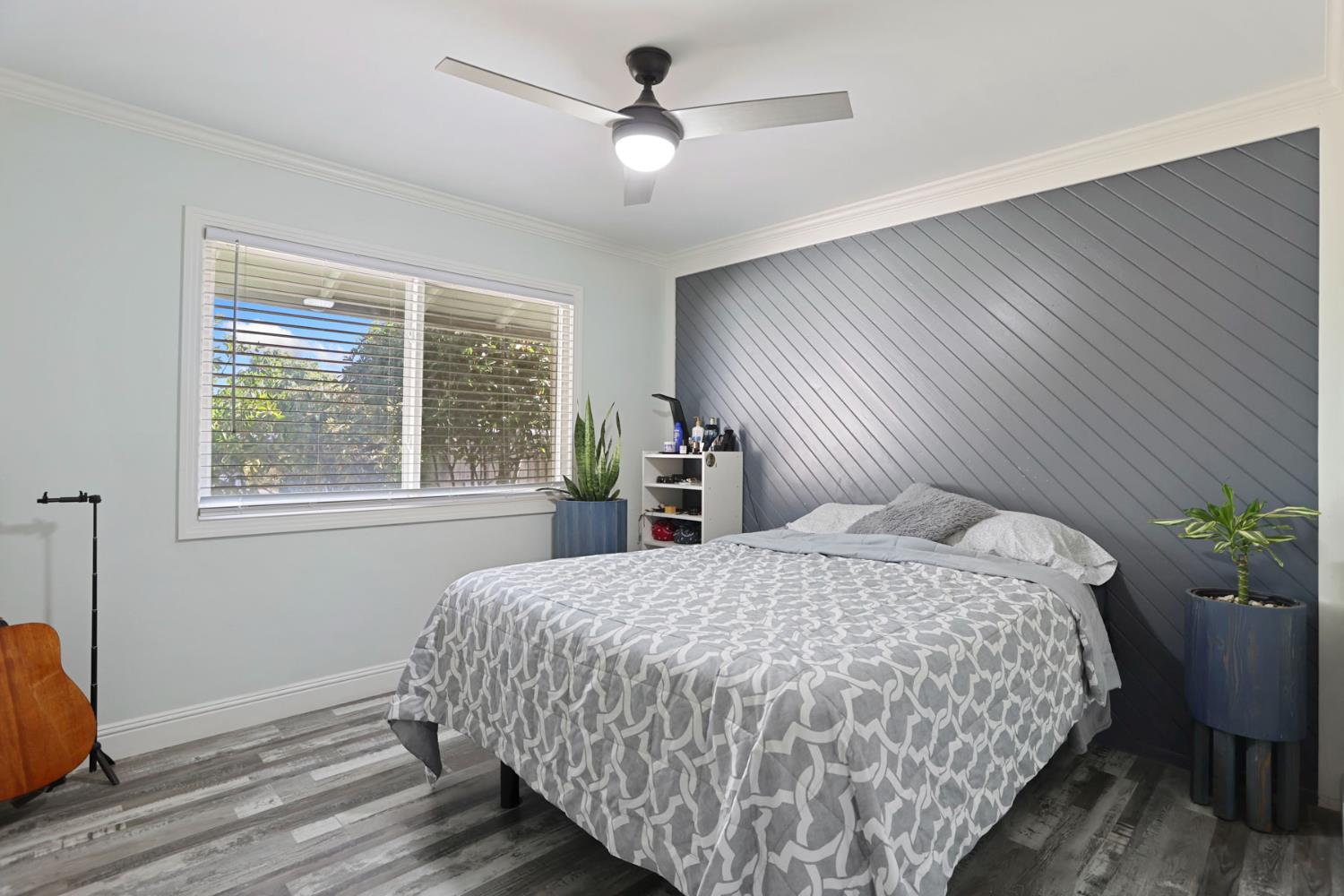 518 West Lincoln Road Stockton, CA 95207 - Photo 25 of 38 a bedroom with a large bed and a chandelier