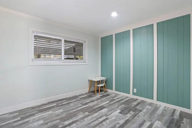 a view of a room with wooden floor and chair