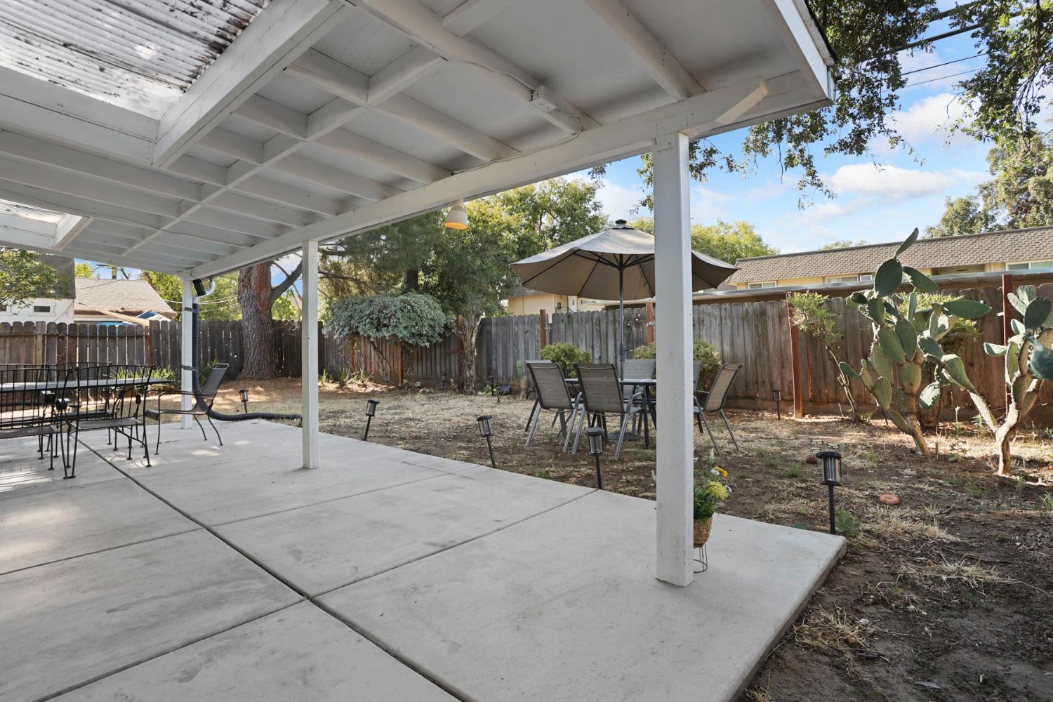 518 West Lincoln Road Stockton, CA 95207 - Photo 31 of 38 a view of a patio with table and chairs potted plants with wooden floor