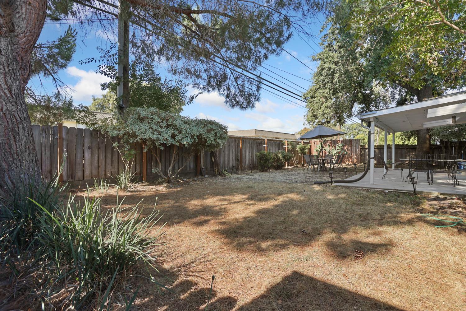 518 West Lincoln Road Stockton, CA 95207 - Photo 32 of 38 a backyard of a house with barbeque oven table and chairs