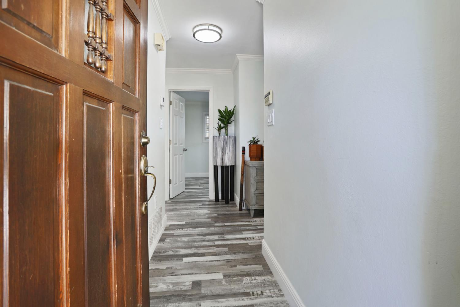518 West Lincoln Road Stockton, CA 95207 - Photo 5 of 38 a view of a hallway with wooden floor and entryway