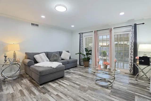 a living room with furniture and a floor to ceiling window