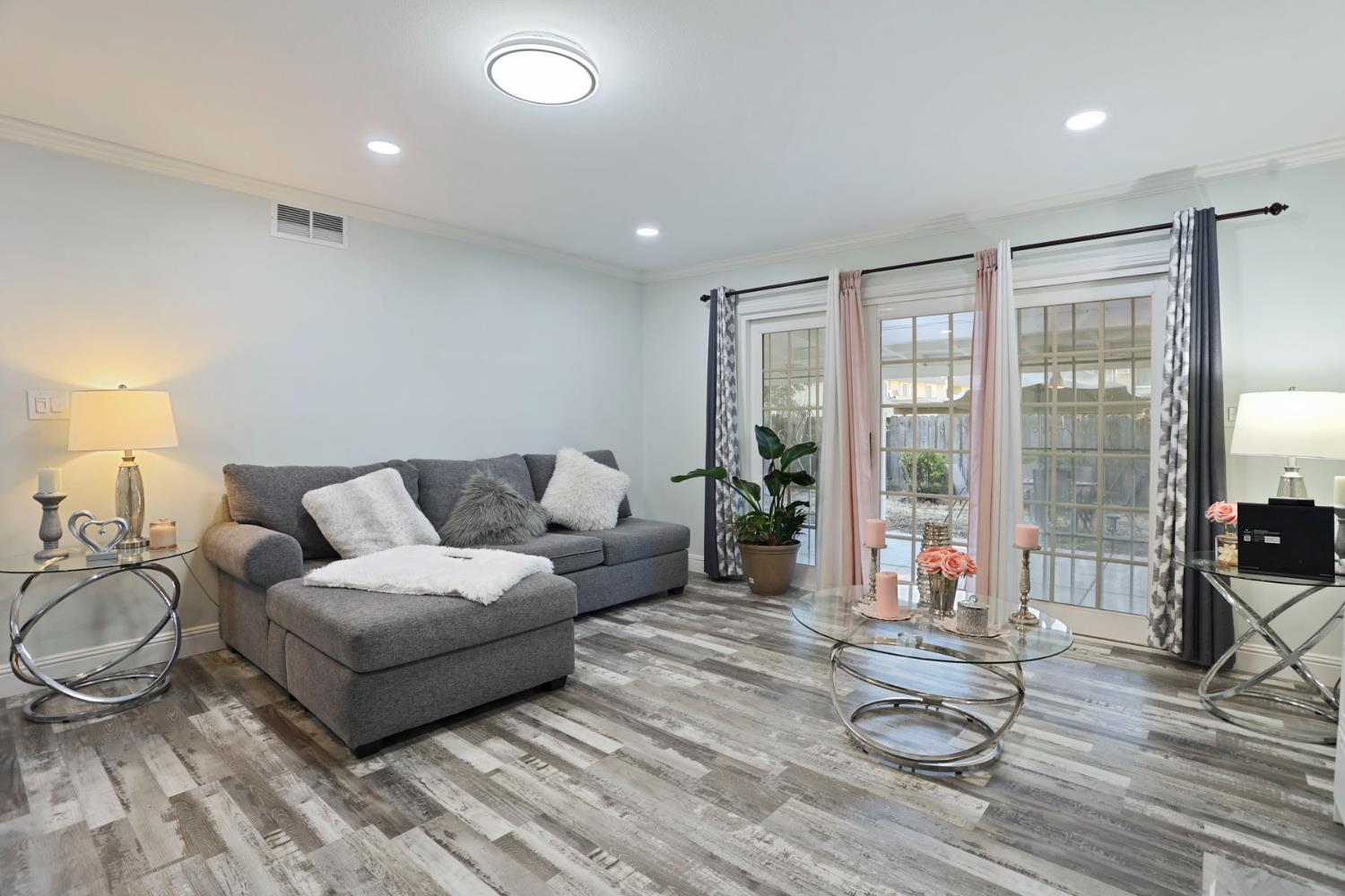 518 West Lincoln Road Stockton, CA 95207 - Photo 8 of 38 a living room with furniture and a floor to ceiling window
