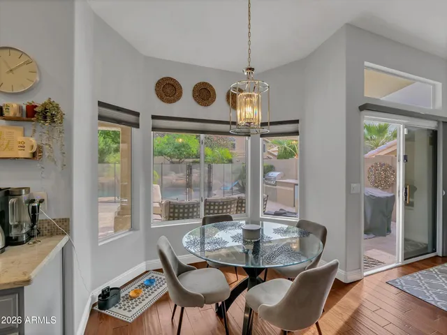 a view of a dining room with furniture wooden floor and chandelier